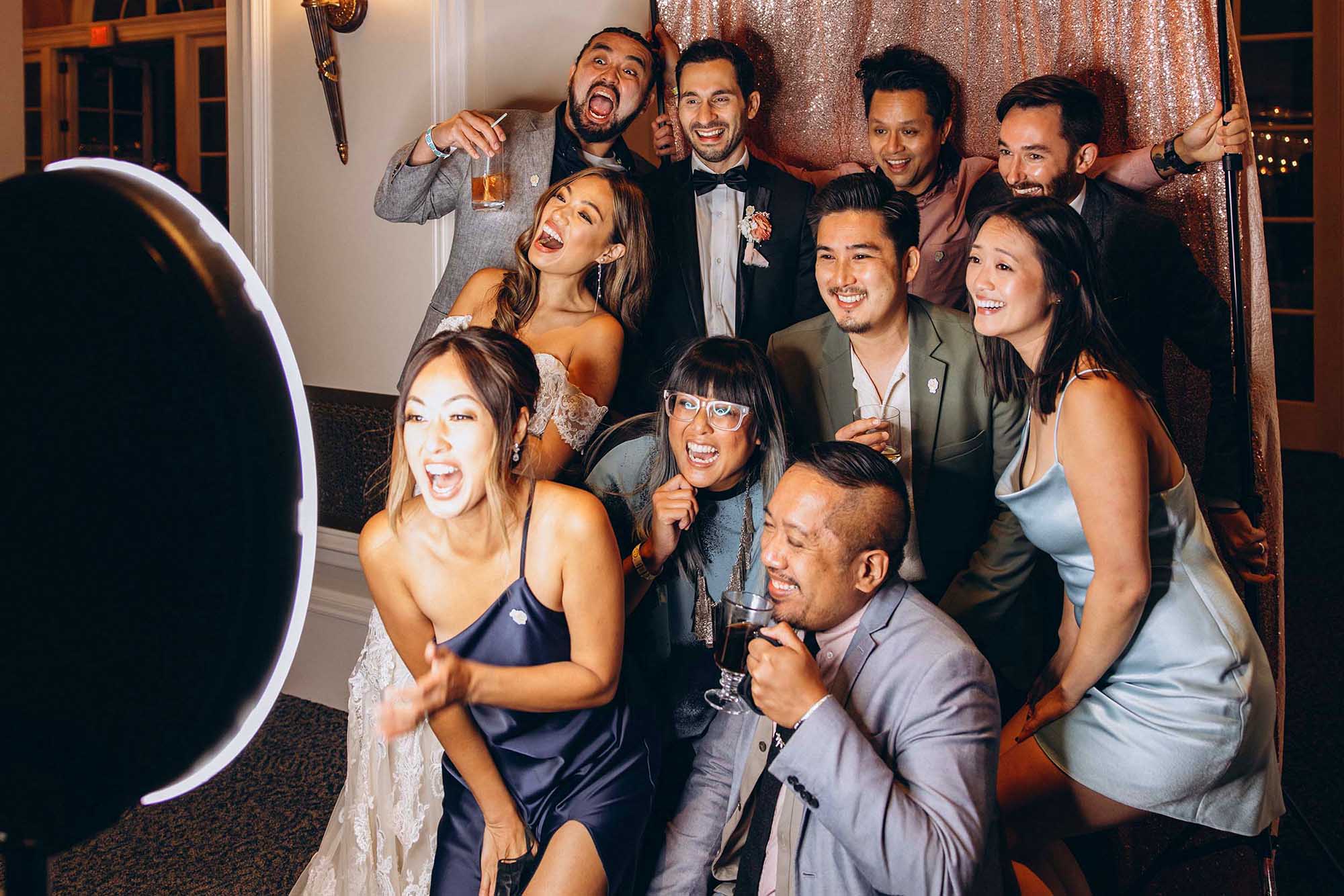 Wedding guests posing in DJ Garret's open-air photo booth
